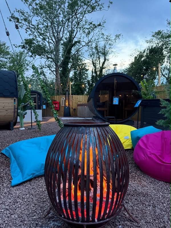 The spa garden at dusk with a glowing fire pit and beanbags